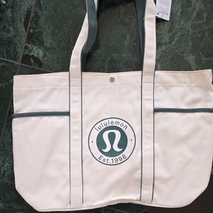 Lululemon Daily Multi-Pocket Canvas Tote Bag in a natural color with a true Gree
